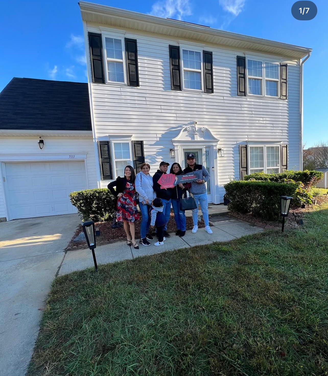 Family in front of sold home — Gastonia NC Alvear Group